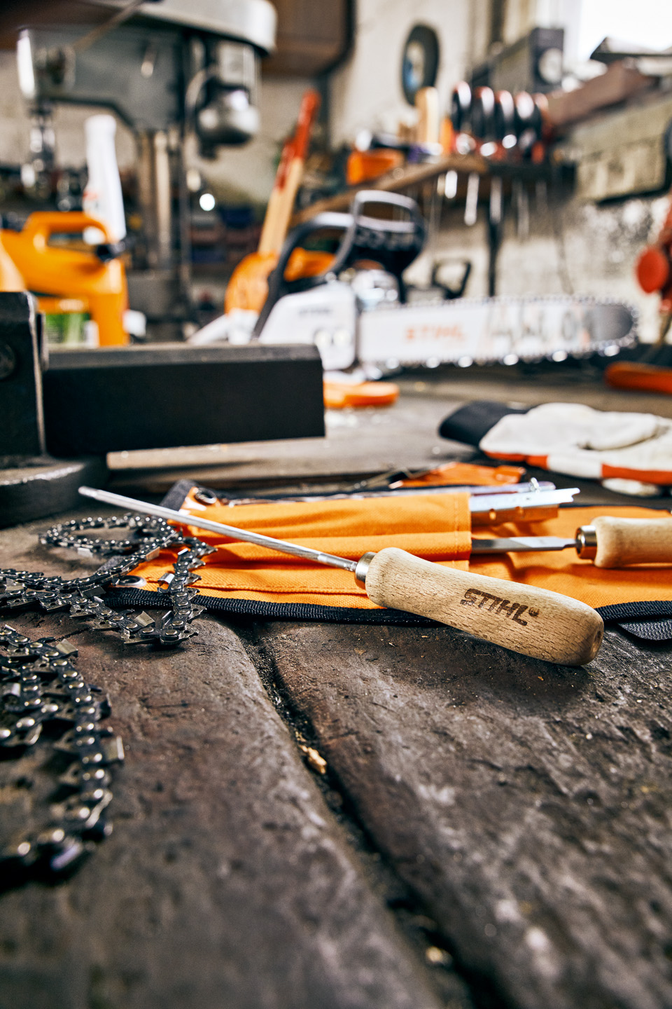 Пили за верижни триони и верига за верижен трион STIHL върху работна маса в сервиз