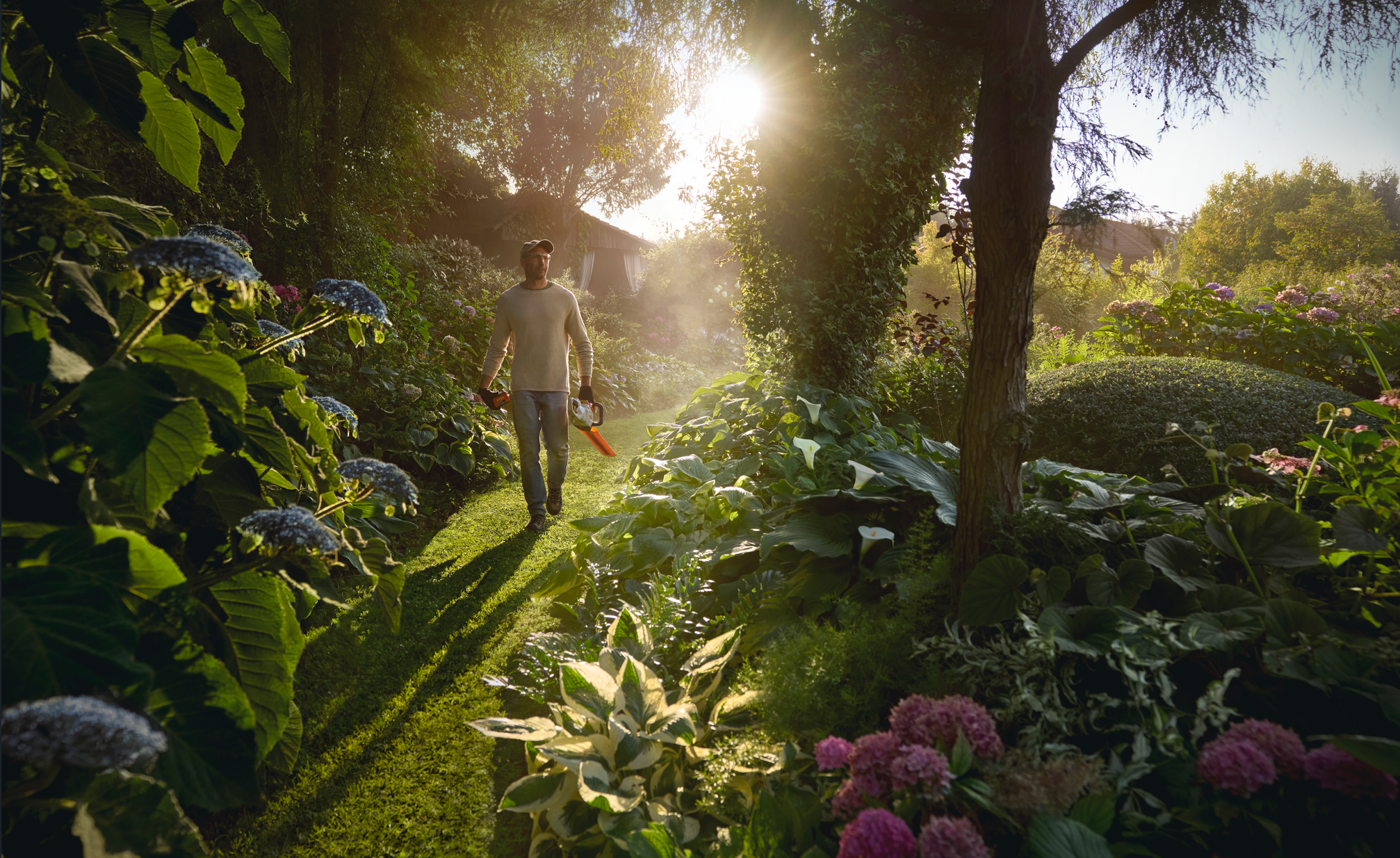 Man in a garden with STIHL tool